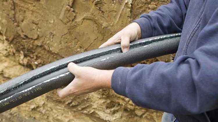 Person holding a broken pipe.